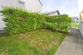 Familienfreundliche "Doppelhaushälfte" mit pflegeleichtem Garten und viel Platz auf drei Etagen - Seitlicher Grünstreifen mit Weg zum Eingang